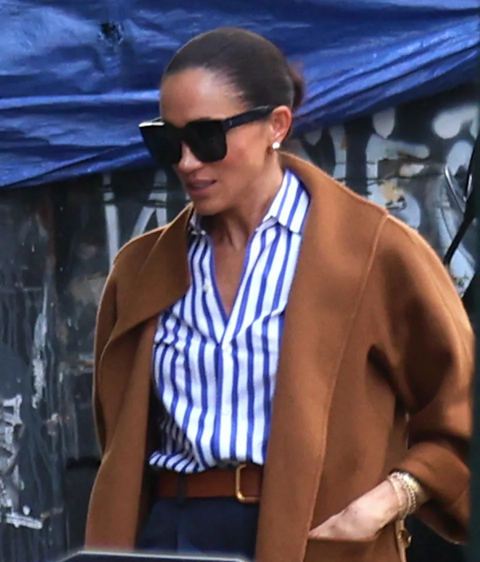 The Duchess of Sussex wore a blue striped shirt and navy pants for the outing to Soho House in New York City. AbacaPress / SplashNews.com