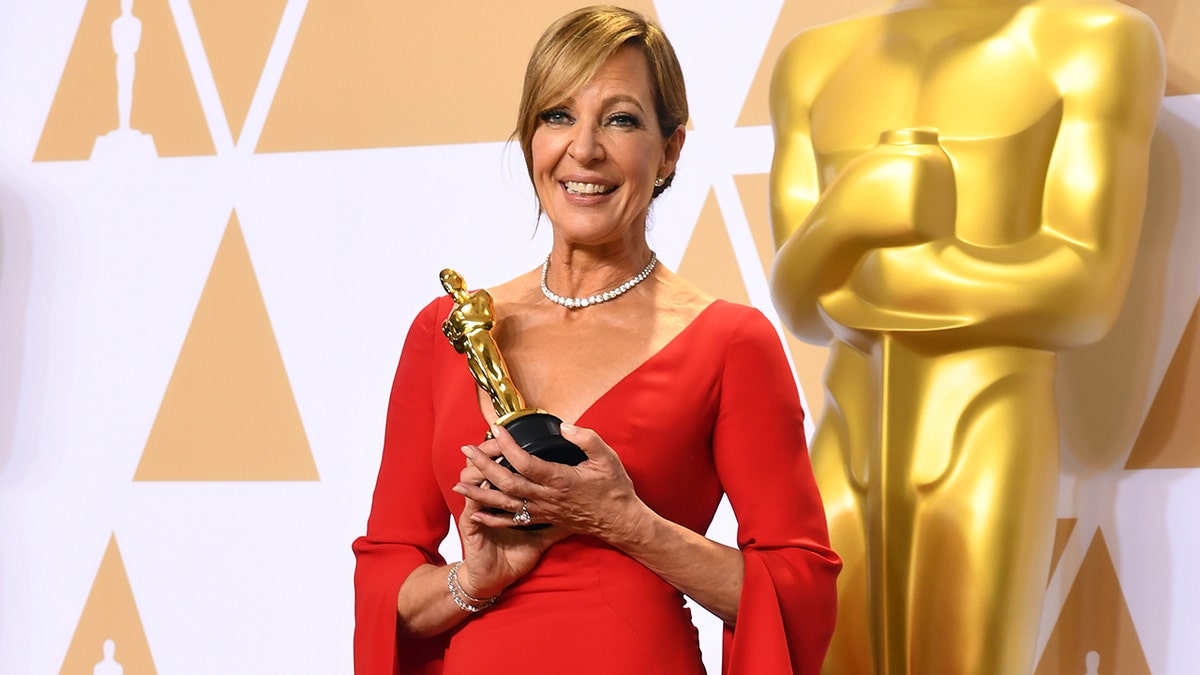 Allison Janney in a red dress holding her Oscar at the 2018 Academy Awards in Los Angeles.
