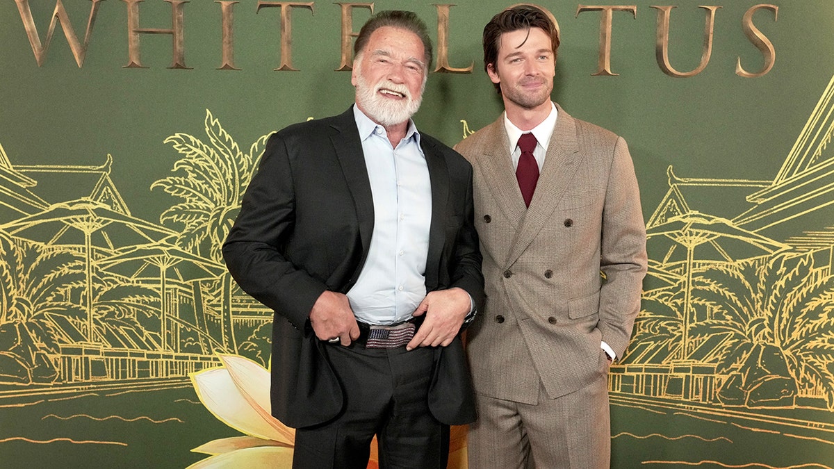 Arnold Schwarzenegger posting with Patrick Schwarzenegger