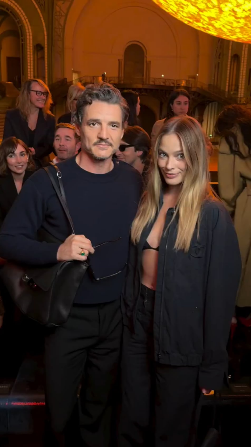 Pedro Pascal and Margot Robbie posing together at the Chanel show