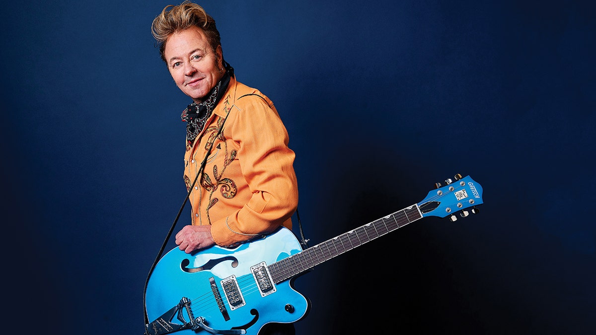 Brian Setzer smiling with blue guitar