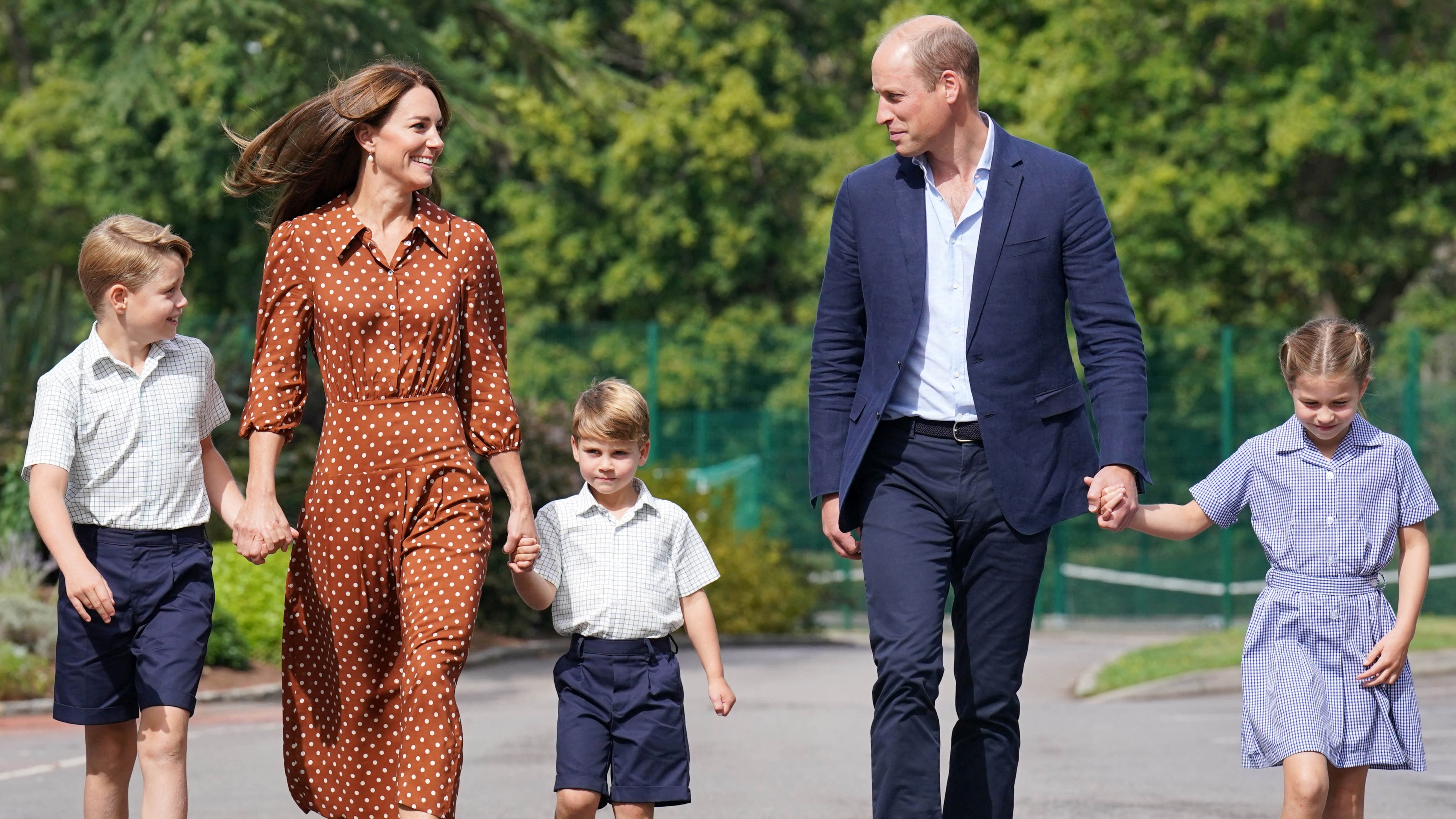 The Wales family hold hands and smile as they arrive at Lambrook School for the kids' settling-in afternoon