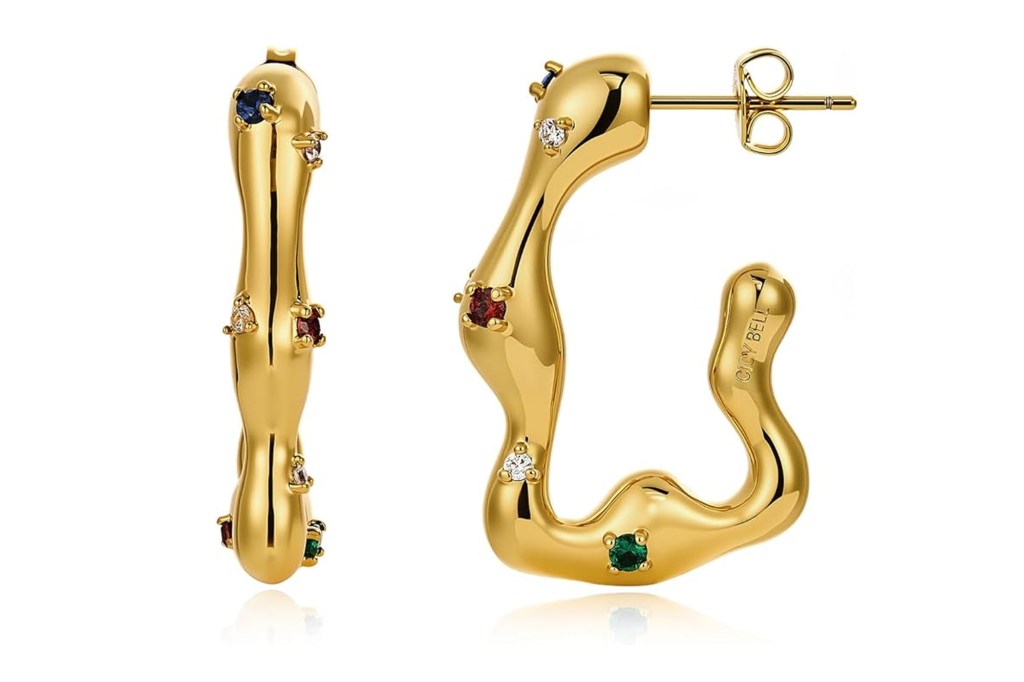 A pair of gold, wavy hoop earrings studded with various colored gems, including red, blue, green, and clear stones.