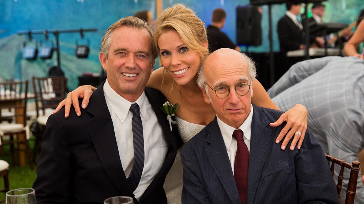 Robert F. Kennedy Jr., Cheryl Hines, and Larry David pose together and smile at RFK Jr.'s and Cheryl Hines' wedding.