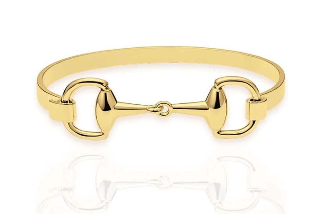 Gold-tone cuff with a snaffle bit design.