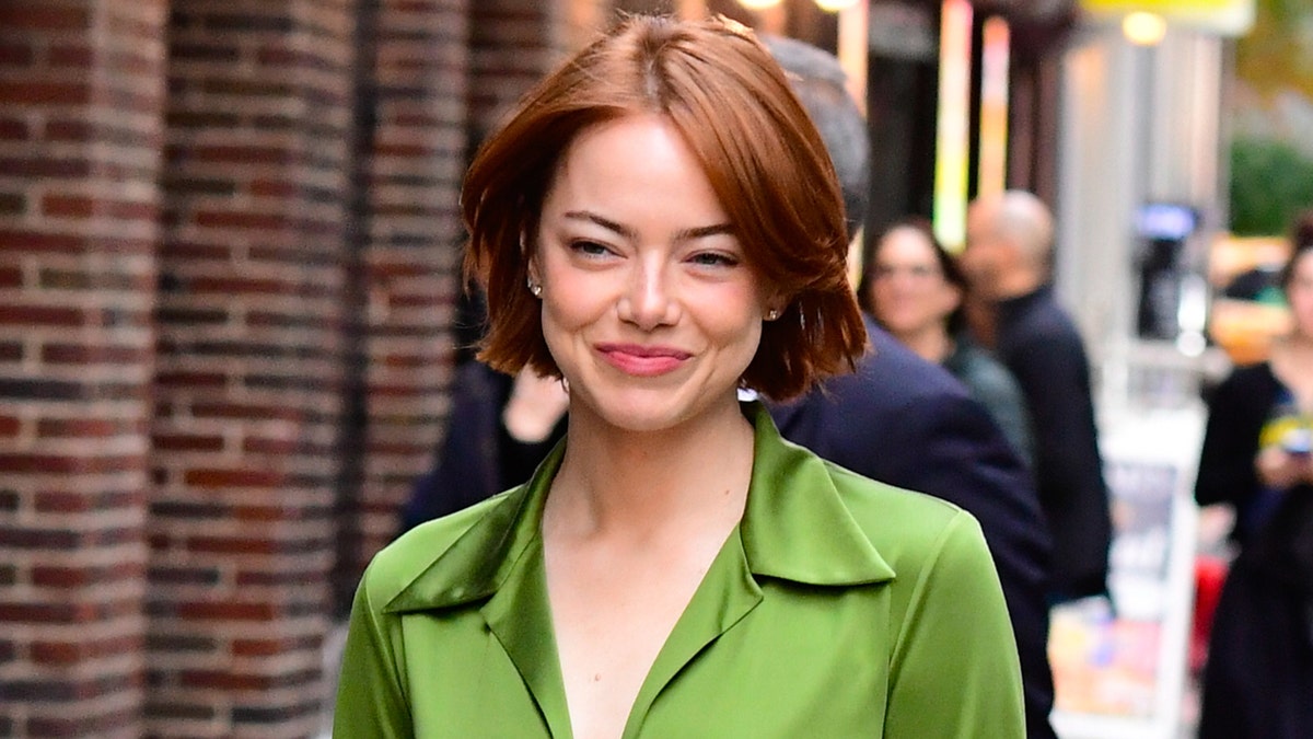 Emma Stone wears a green top while walking around NYC