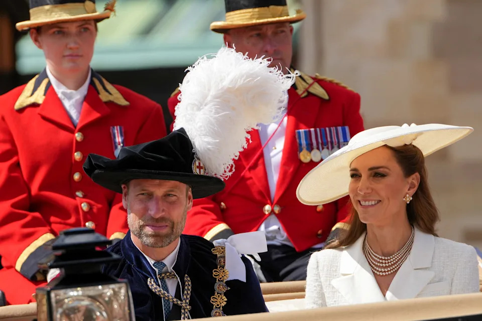 Prince William and Kate Middleton riding in a carriage wearing hats on Garter Day