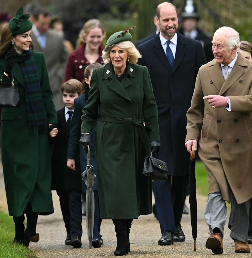  King Charles, Queen Camilla and the Royal Family walking to church on Christmas day wearing long coats and hats. 
