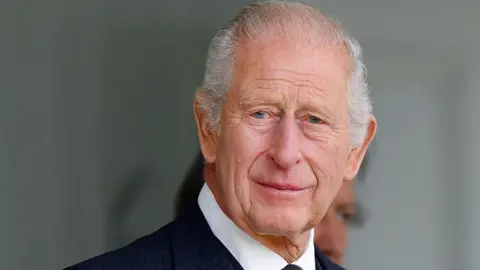 Getty Images King Charles III ina dark suit and white shirt