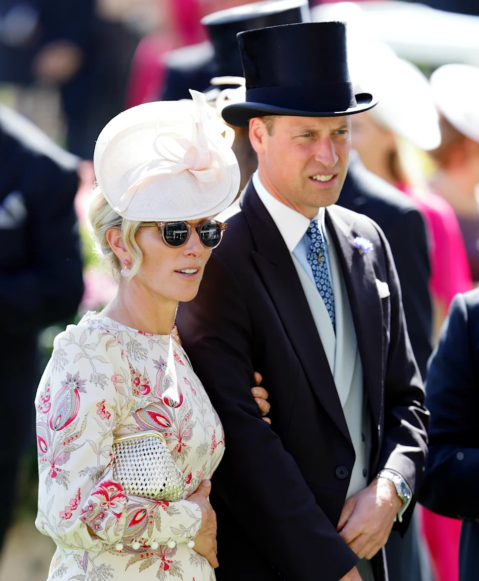 Zara Tindall wearing a white paisley dress and holding Prince William's arm at Royal Ascot