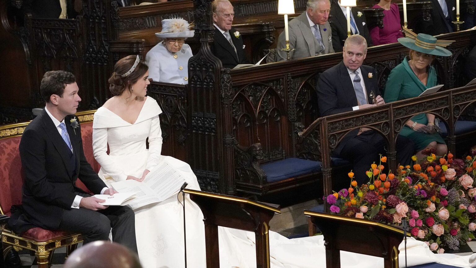 Why Princess Eugenie Left a Prominent Seat Empty at Her Royal Wedding WINDSOR, ENGLAND - OCTOBER 12: Princess Eugenie and her husband Jack Brooksbank, look back towards the Duke of York and Sarah, Duchess of York (seated front) and Queen Elizabeth II, the Duke of Edinburgh, Prince of Wales, the Duke and Duchess of Cambridge, and the Duke and Duchess of Sussex, during their wedding at St George's Chapel in Windsor Castle on October 12, 2018 in Windsor, England. (Photo by Danny Lawson - WPA Pool/Getty Images)