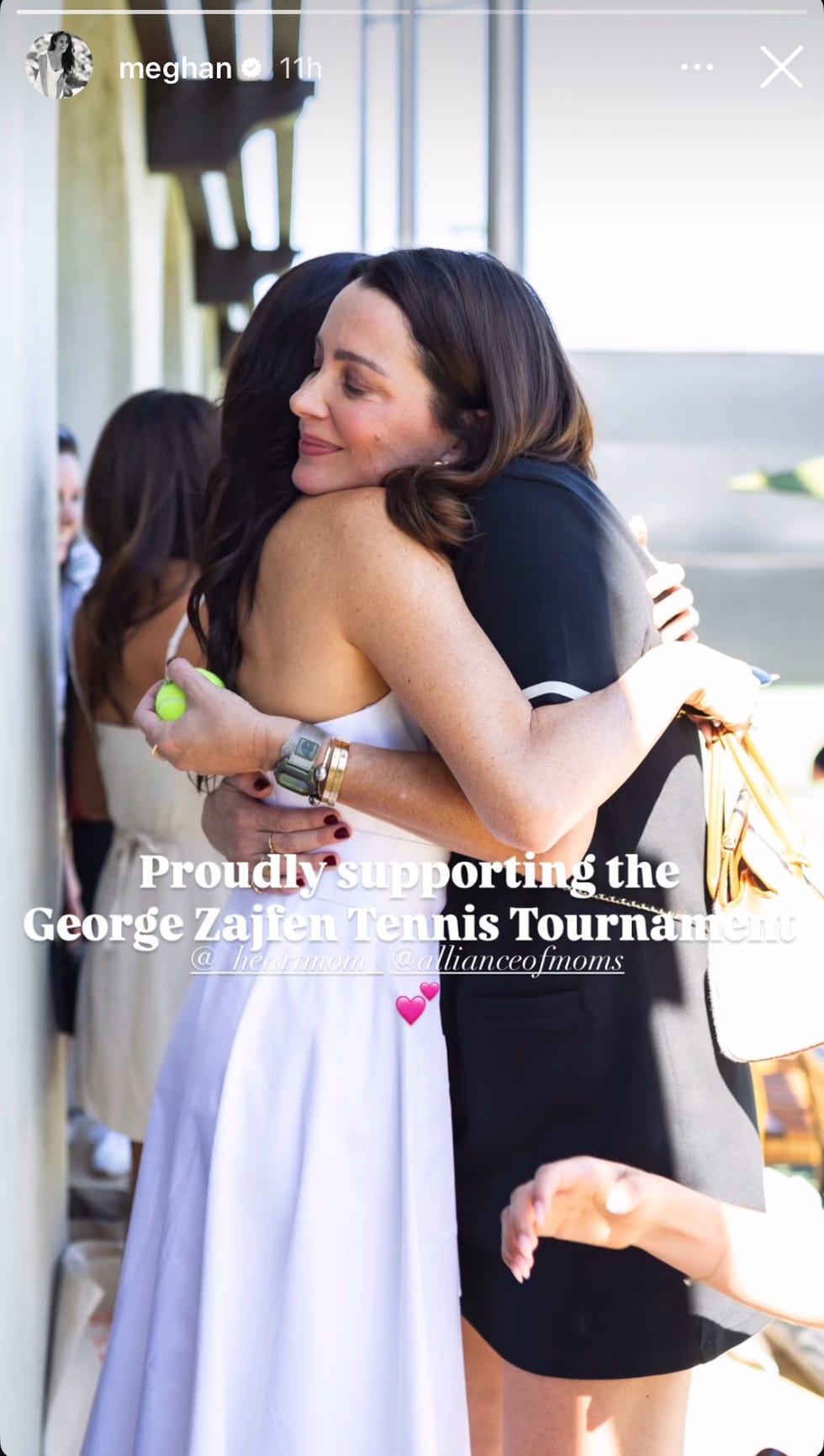 individuals embracing at a tennis tournament event