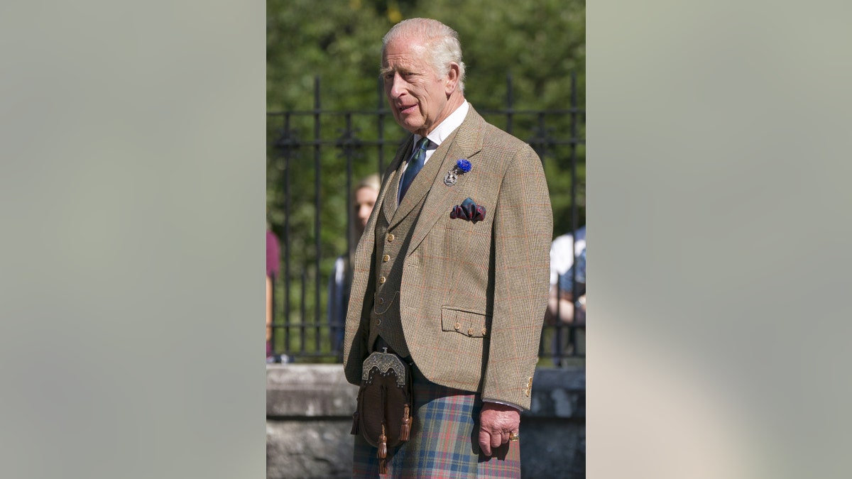 King Charles in Scottish wear outdoors.