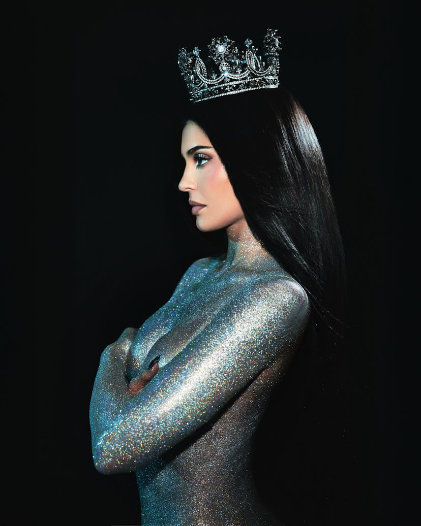 Kylie Jenner wears nothing but glitter and a g-string. 