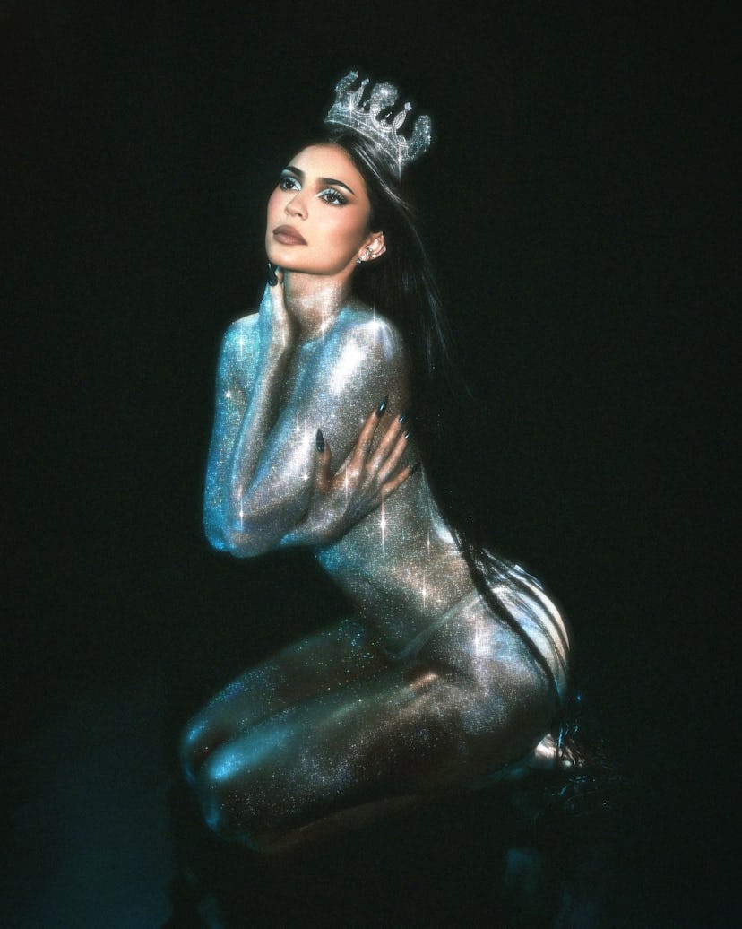 Kylie Jenner wears nothing but glitter and a g-string. 