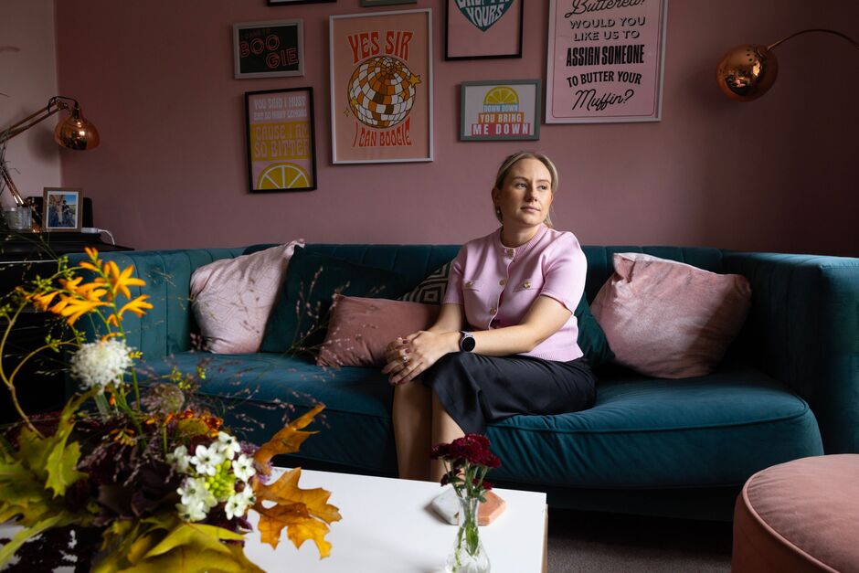 Emily Ferguson sits on a sofa