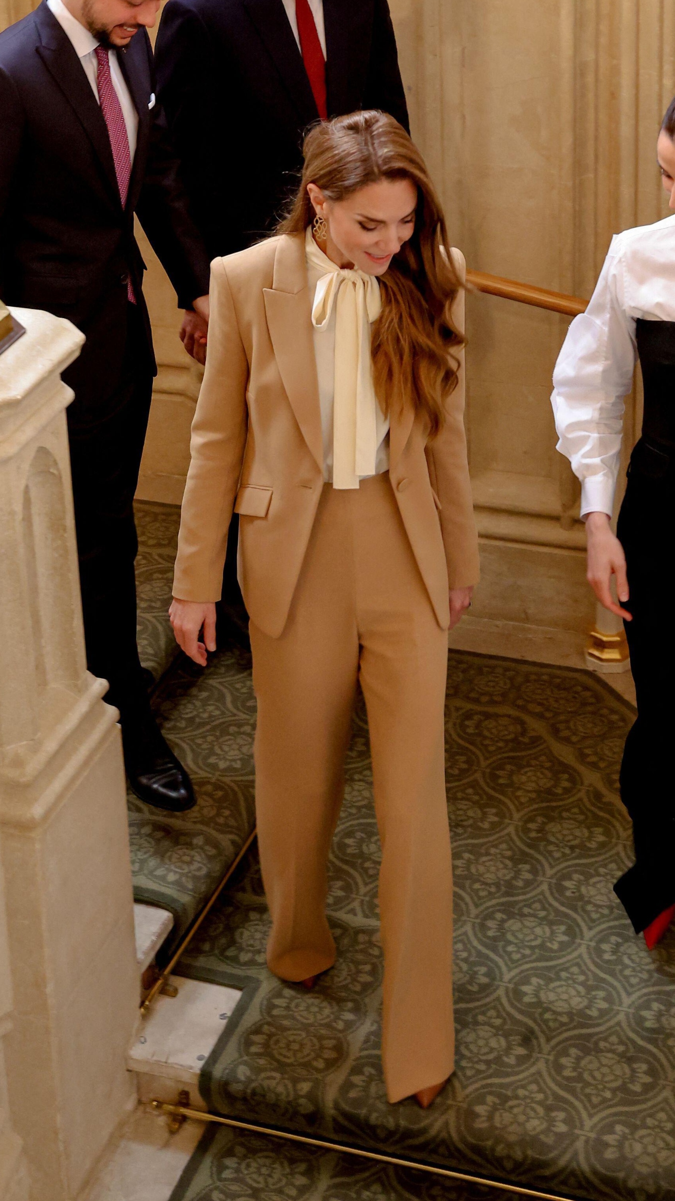 Catherine, Princess of Wales walks downstairs as she receives Jordan's Crown Prince Al Hussein bin Abdullah II and his wife Princess Rajwa Al Hussein at Windsor Castle