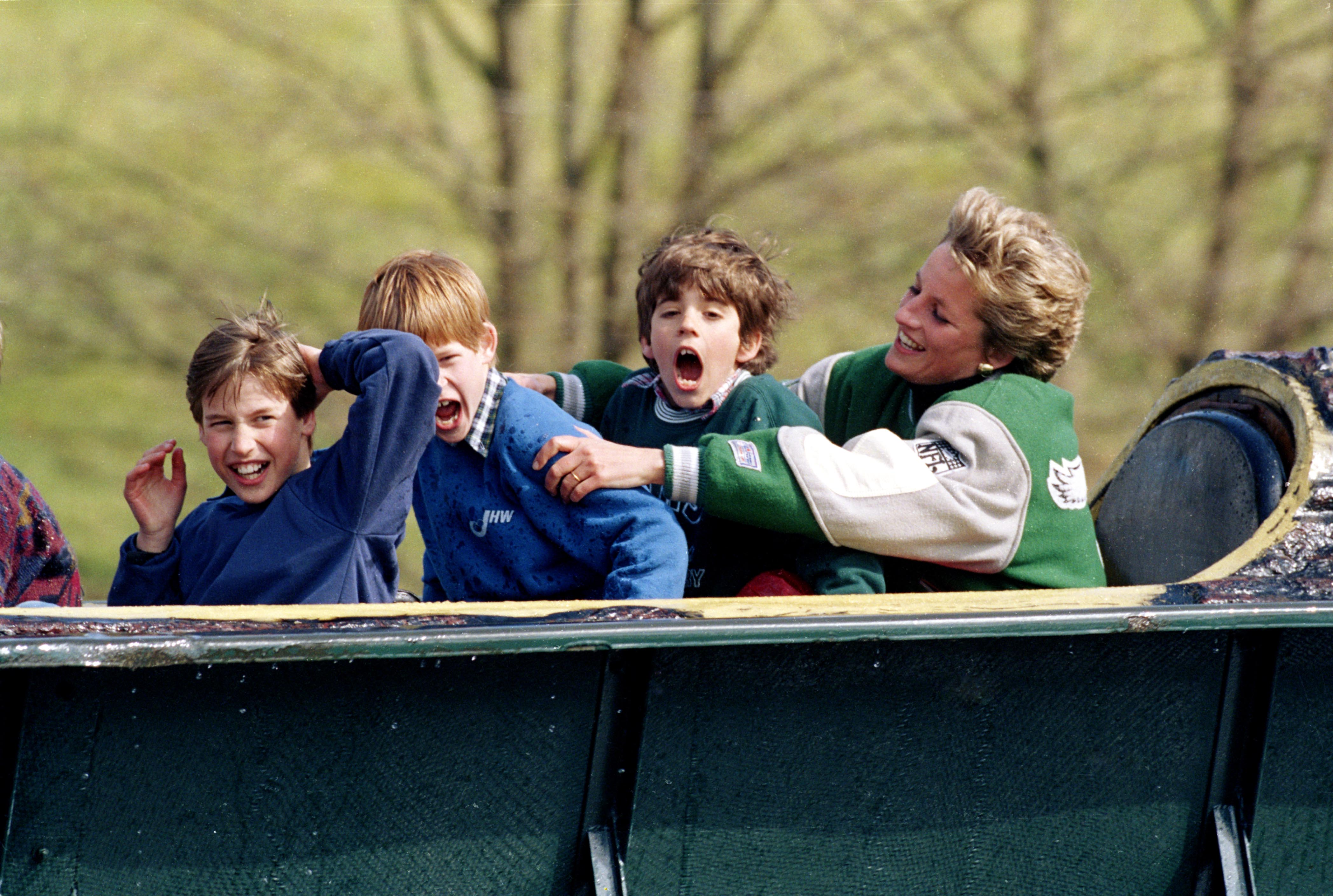 Princess Diana wearing a Philadelphia Eagles jacket with Prince Harry and Prince William on a log flume