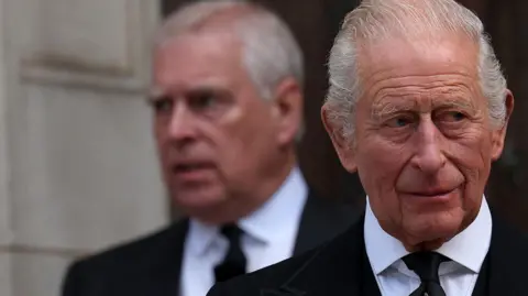 Getty Images King Charles in the foreground of the image looks away to the left of the frame, whilst his younger brother Andrew Mountbatten Windsor is seen behind him, slightly out of focus.