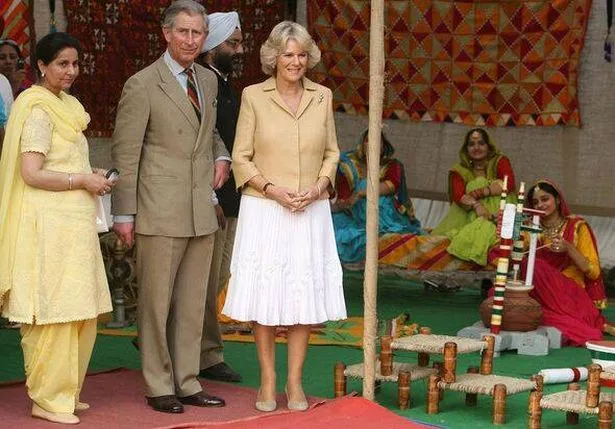 Britain's Prince Charles (2L) and his wi