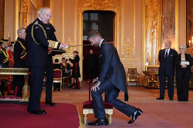 David Beckham being knighted by King Charles