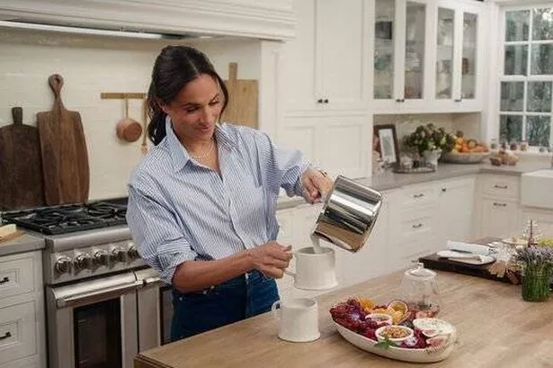 Meghan Markle pouring milk into a cup from a saucepan