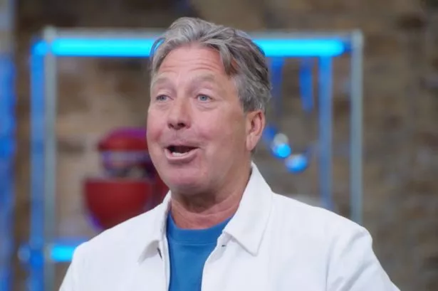 John Torode in a blue top and white jacket.