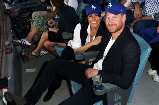  Prince Harry and Megan Markle pose for a photo during Game Four of the 2025 World Series