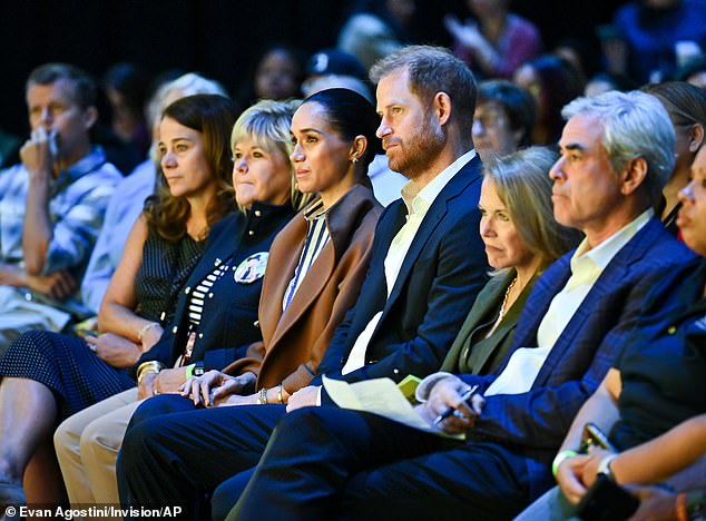 According to Mr Bower, 'Harry assured his family' that the couple would 'never' use their titles 'to make money' - but less than a month after the Sandringham Summit, Harry jetted out to Miami for the JP Morgan event. The Sussexes (centre) are pictured at a mental health awareness event in New York on October 10
