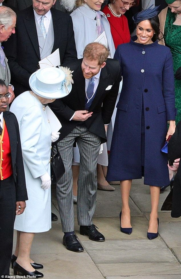 During happier times for the family, Queen Elizabeth was pictured with tje Duke and Duchess of Sussex outside St George's Chapel in Windsor Castle, following the wedding of Princess Eugenie to Jack Brooksbank