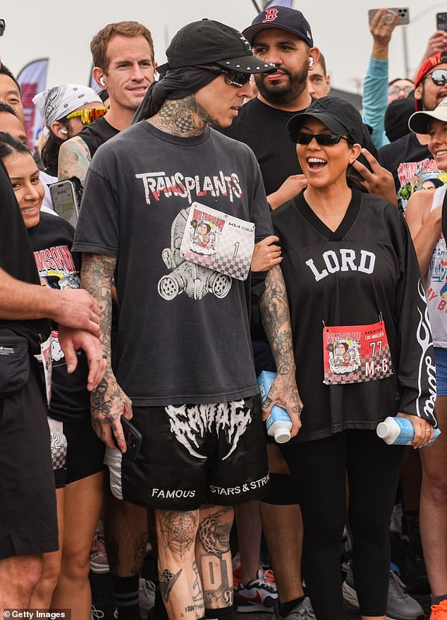 In one scene, the Blink-182 drummer, 49, insisted on holding his wife's hand as they ran side by side, despite her repeatedly saying she was 'not prepared' and was still breastfeeding