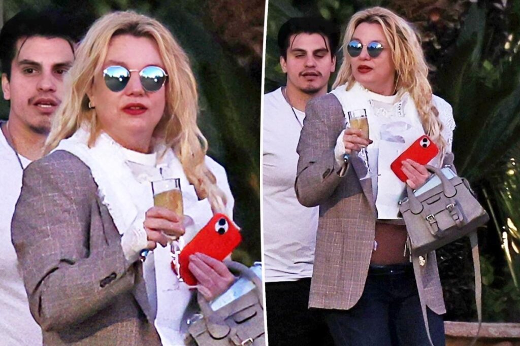 Britney Spears spotted walking to car with champagne flute as family remains concerned over erratic behavior Britney Spears spotted walking to car with champagne flute as family remains concerned over erratic behavior