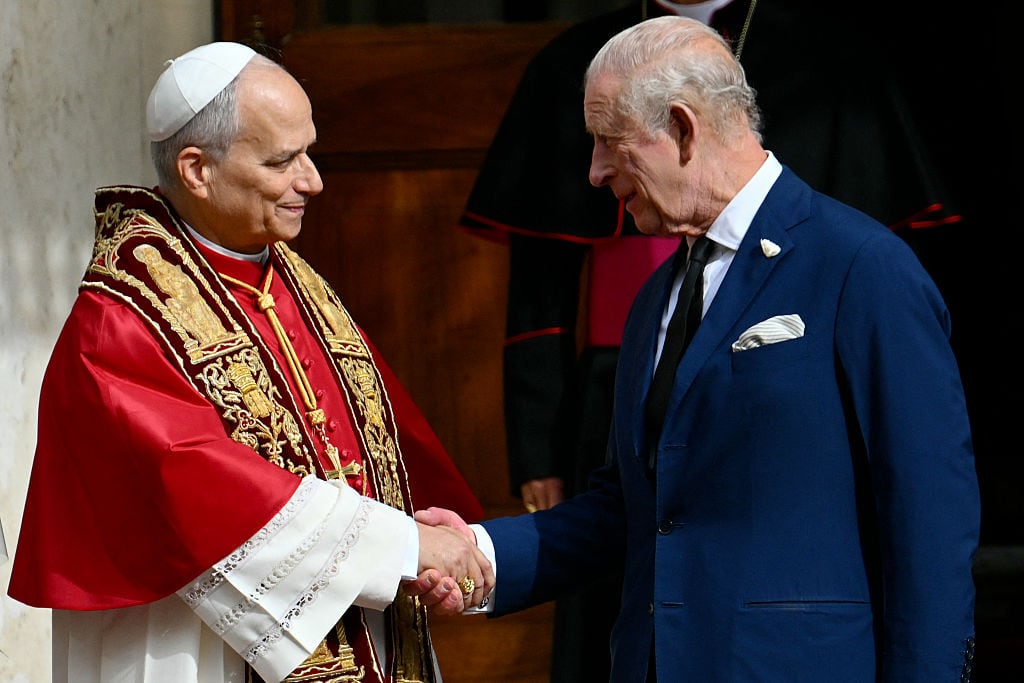 Two people shake hands.