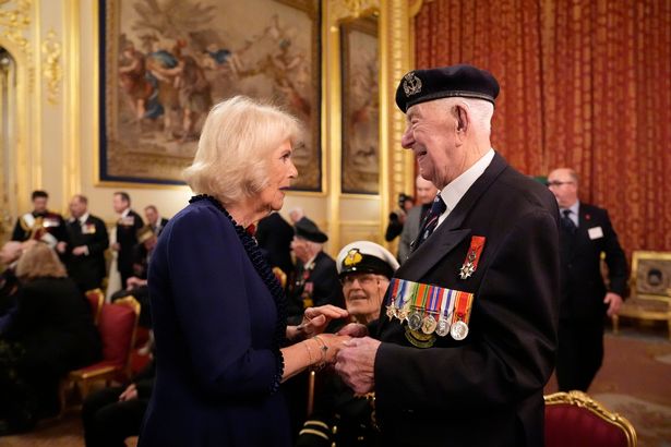 Queen Camilla speaking to veteran Henry Rice