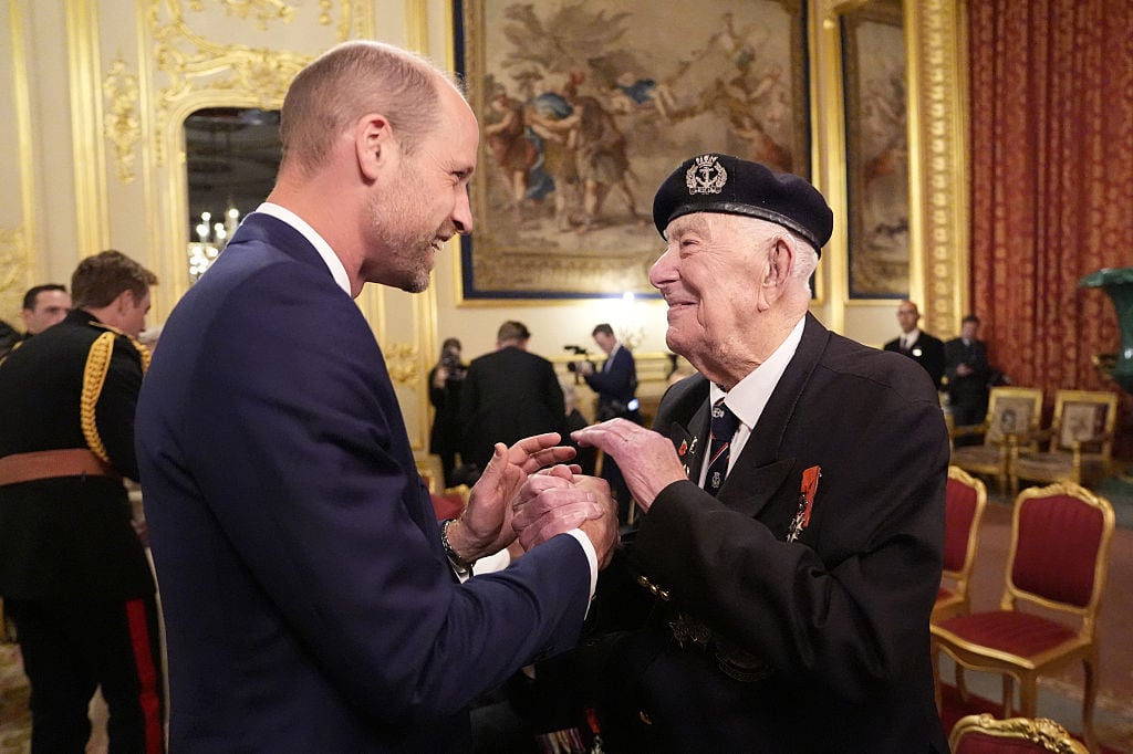 Two people shake hands.