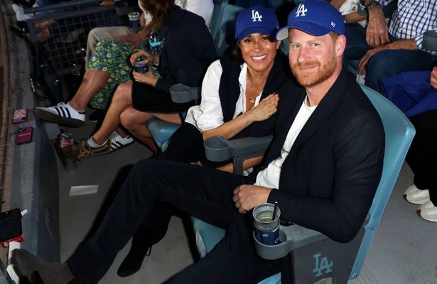 Prince Harry and Meghan, Duchess of Sussex wore LA Dodgers caps at the baseball World Series