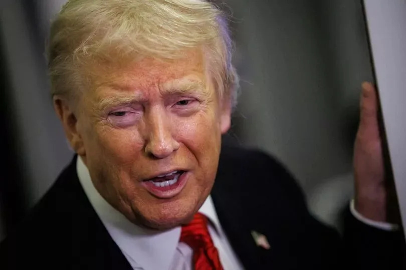 US President Donald Trump speaks to reporters aboard Air Force One en route to the White House on November 2, 2025