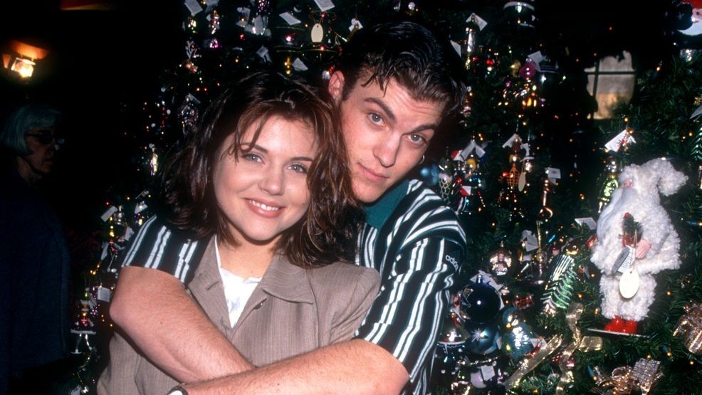 Actor Brian Austin Green and ex girlfriend actress Tiffani-Amber Thiessen pose for a portrait in front of their Christmas tree circa December, 1994 in Los Angeles, California. (Credit: Ron Davis/Getty Images)