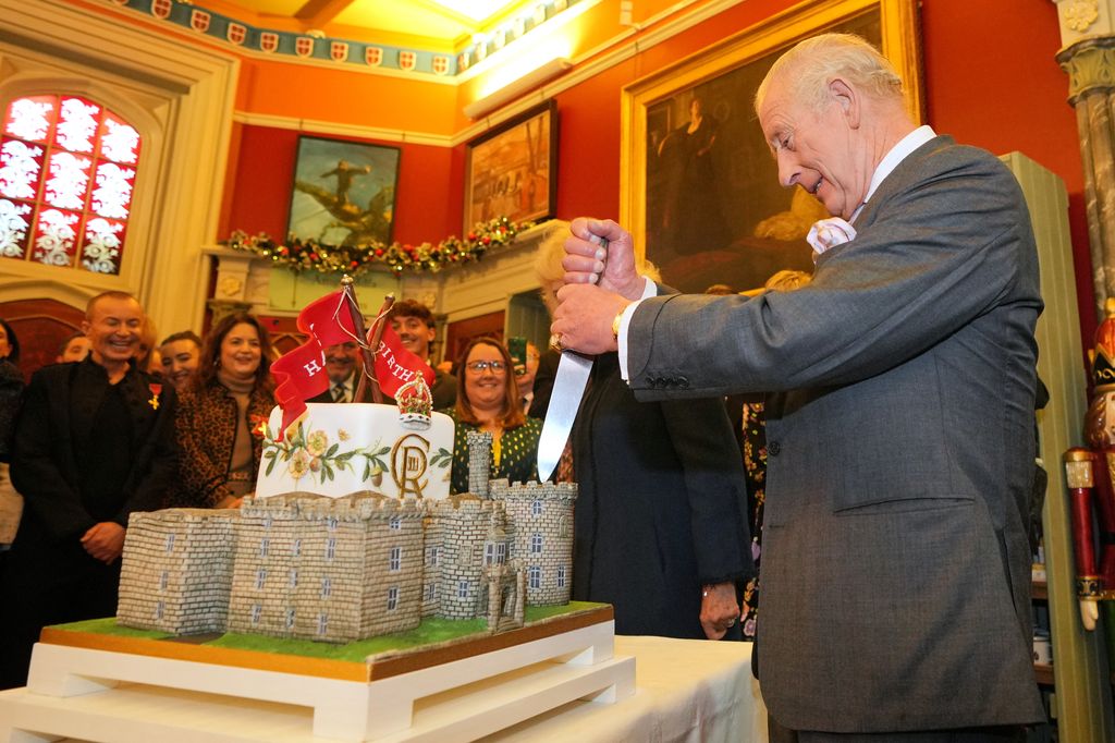 The King cuts a cake
