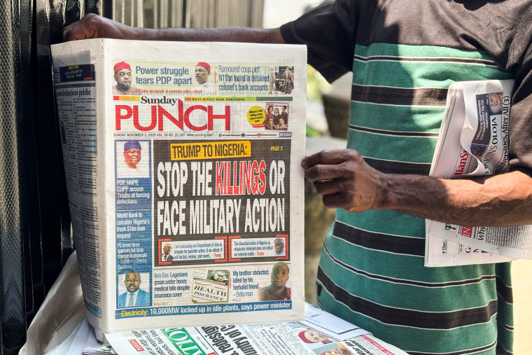 A vendor sells local newspapers with headlines referring to US President Donald Trump's comments about Nigeria.