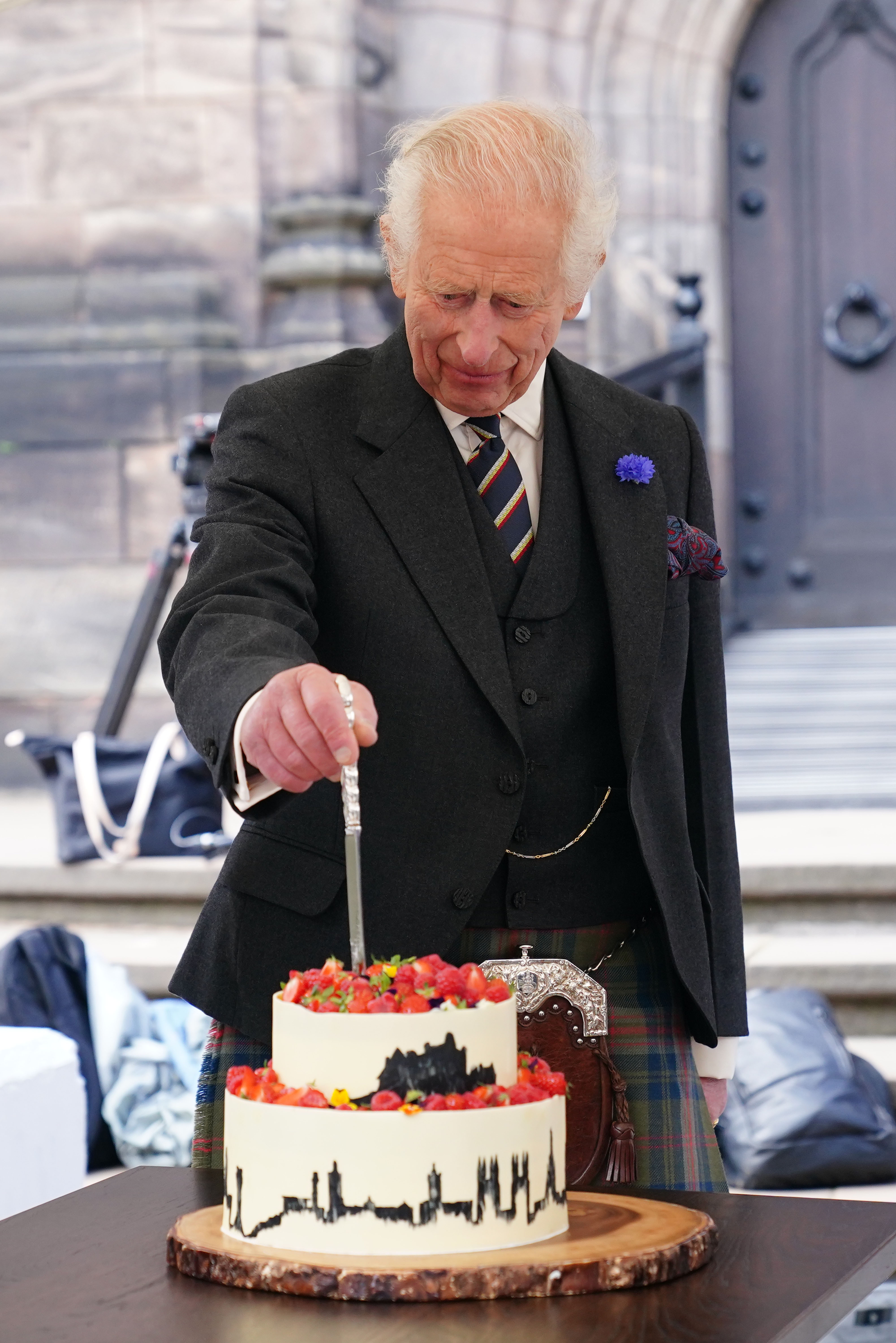 King Charles cutting a cake