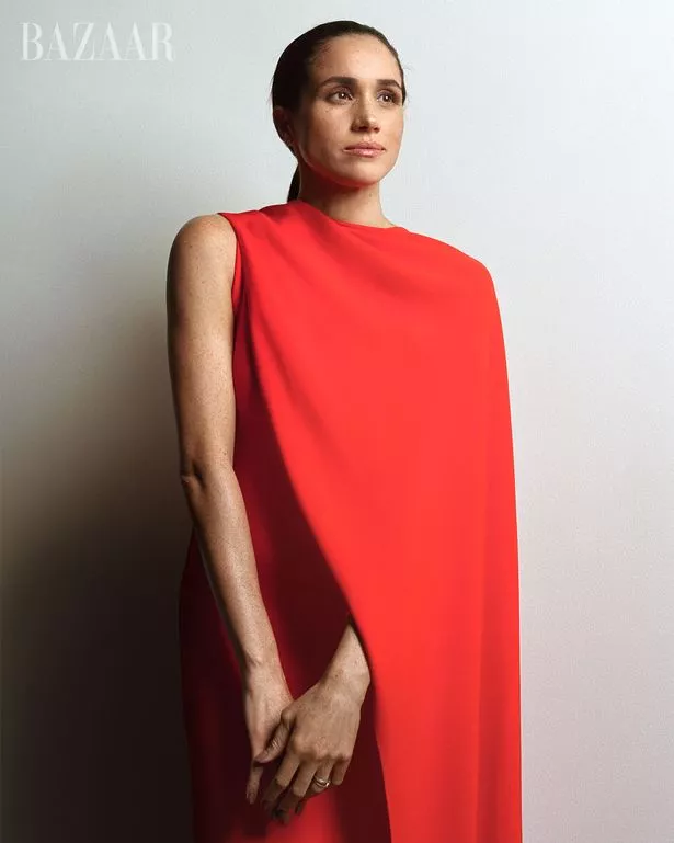 Meghan posing in a red dress for the magazine