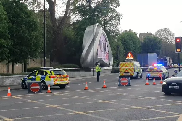 The crime scene set up after the fatal crash in West London with police guarding the cordon 