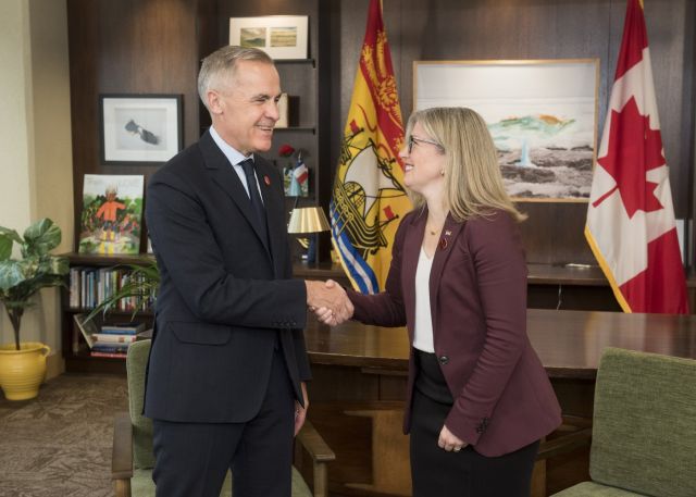 Prime Minister Mark Carney left, meets with New Brunswick Premier Susan Holt in her office in Fredericton, N.B., on Monday, Nov. 10, 2025. THE CANADIAN PRESS/Stephen MacGillivray