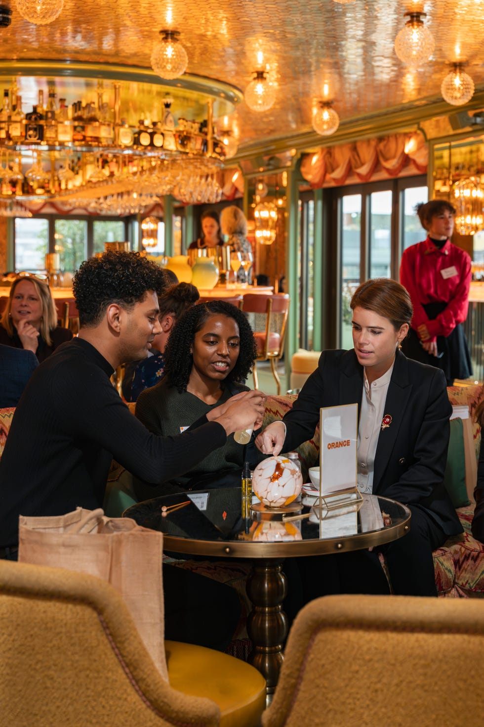 A social gathering at a lavish bar setting with people engaged in conversation. A social gathering at a lavish bar setting with people engaged in conversation.