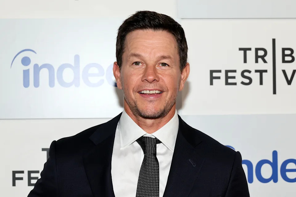 Man in a suit and tie at a film festival event, posing for photos