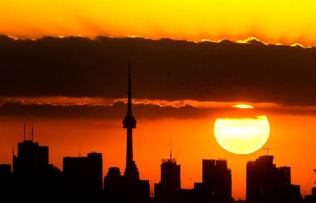 The sun rises over the Toronto skyline, Tuesday, June 24, 2025. THE CANADIAN PRESS/Frank Gunn