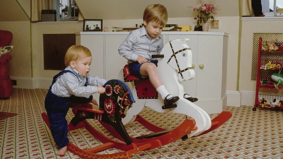 Prince Harry and Prince William play on their rocking horses at their home in Kensington Palace, London, England, 22nd October 1985