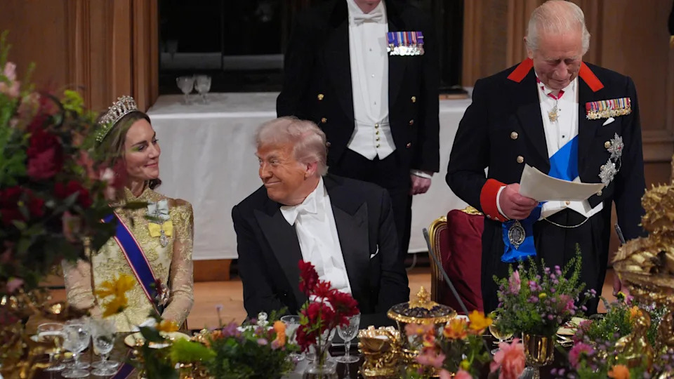 Kate Middleton wearing a gold dress sitting next to Donald Trump at a banquet
