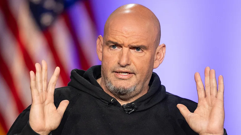 Sen. John Fetterman with his hands raised